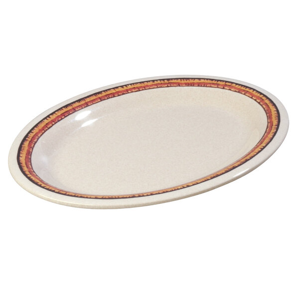 A white oval Carlisle melamine platter with a red and orange mosaic border.
