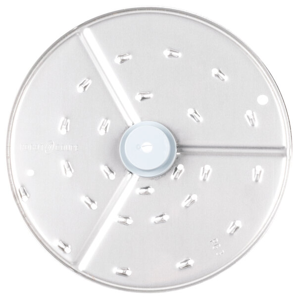 A circular metal food processor disc with holes in it.