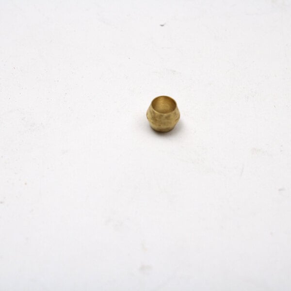 A small round gold ferrule on a white surface.