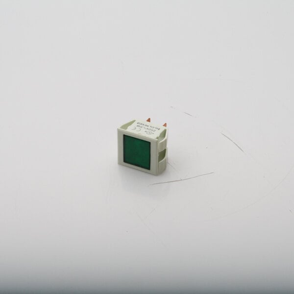 A small square white object with a green square.