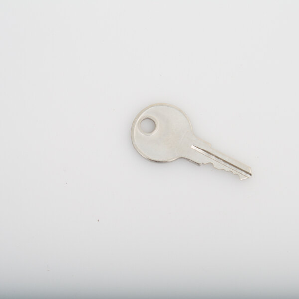 A Traulsen key on a white surface.