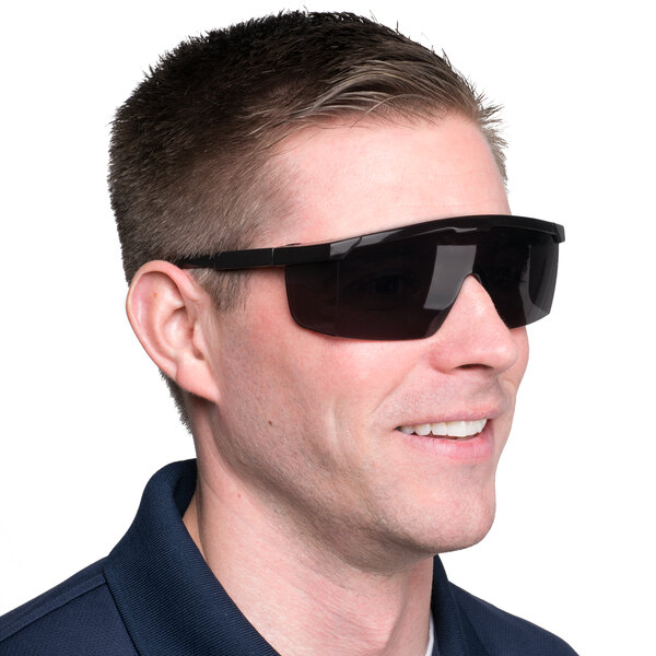 A man wearing Cordova Scratch Resistant Safety Glasses with gray lenses.