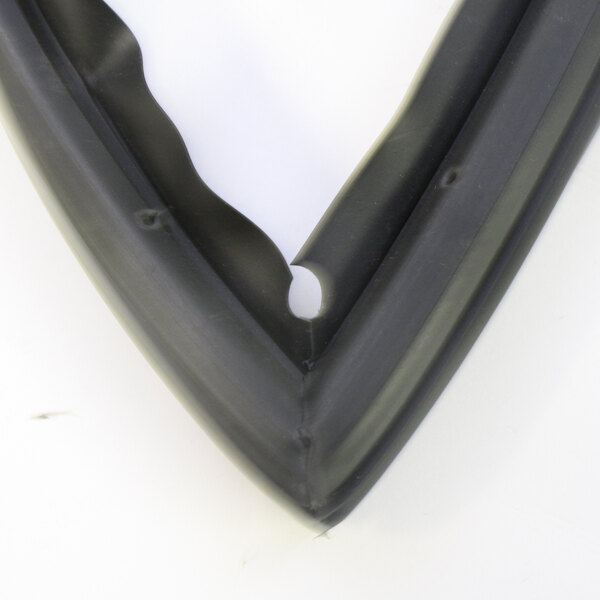 A close-up of a black rubber corner with a hole in it on a white surface.