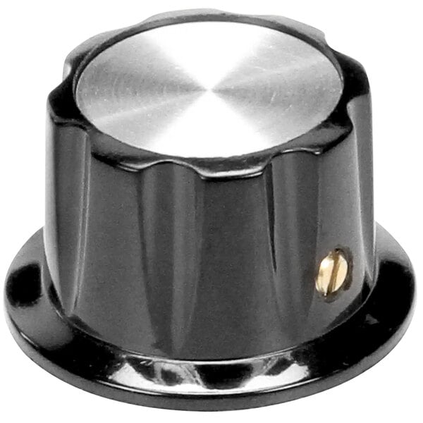 A close-up of a black and silver Bakers Pride oven control knob with a gold metal button.