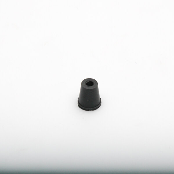 A black plastic cone with a hole on a white surface.