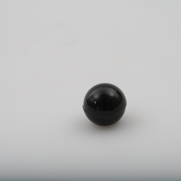 A black round knob with a white surface.