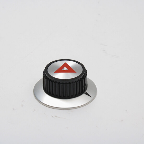 A black and silver knob with a red triangle.