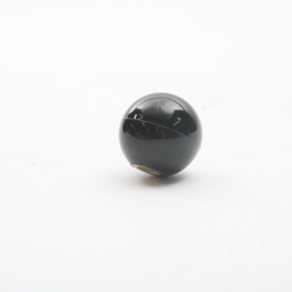 A close up of a black Bakers Pride knob with a hole in it.