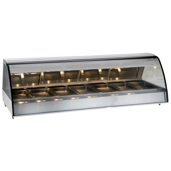 The interior of a stainless steel Alto-Shaam countertop heated display case with curved glass over food trays.