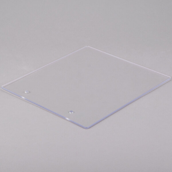 A clear plastic square panel with a small hole in it.