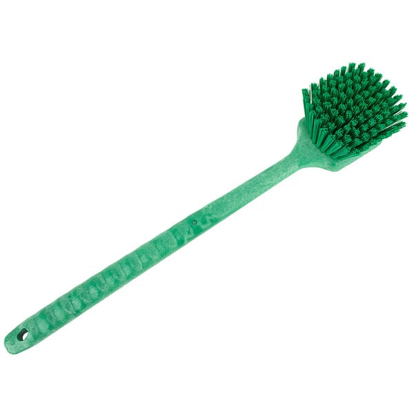 A Carlisle Sparta green plastic brush with bristles and a handle.
