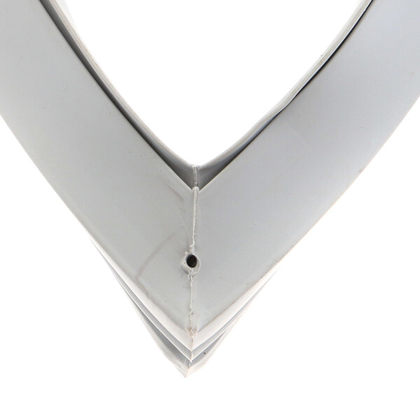 A close-up of a white triangle-shaped metal corner with a hole.