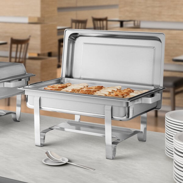 A stainless steel Choice Economy chafer on a buffet table.