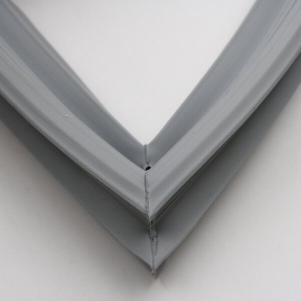 A close-up of a grey triangle-shaped corner of a Randell IN GSK1010 door gasket.