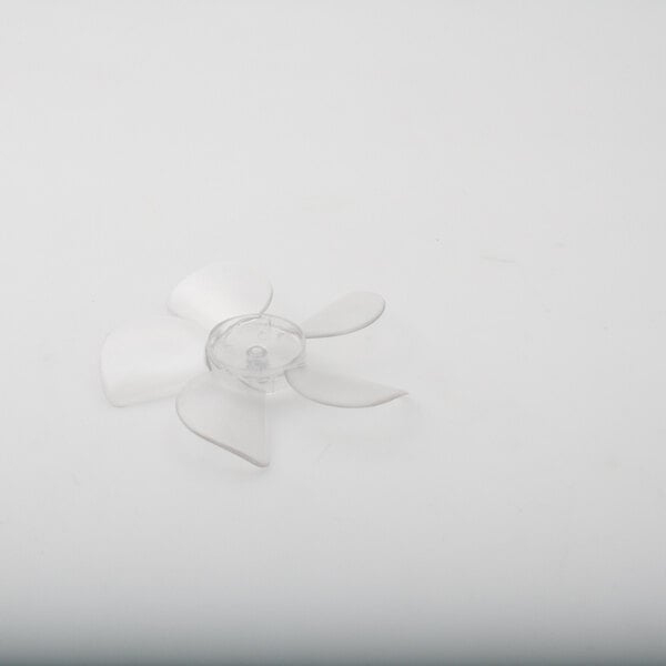 A plastic fan blade on a white surface.