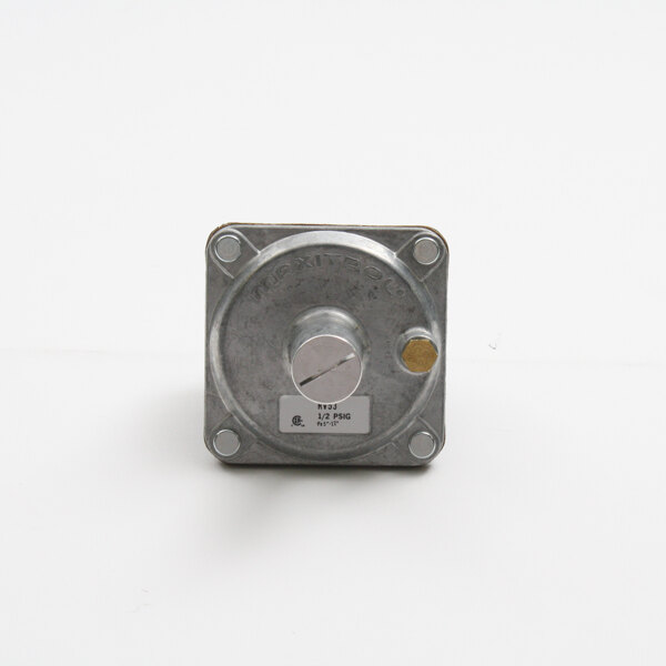 A close-up of a metal Bakers Pride pressure regulator square object with a knob.