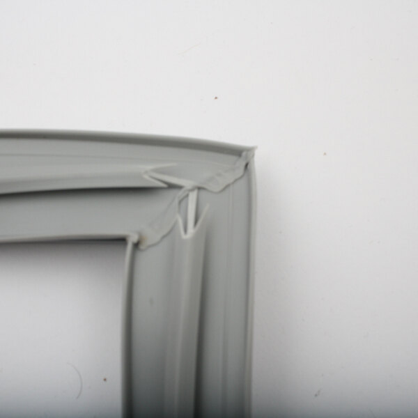 A close up of a white plastic corner piece with a right hinge gasket.