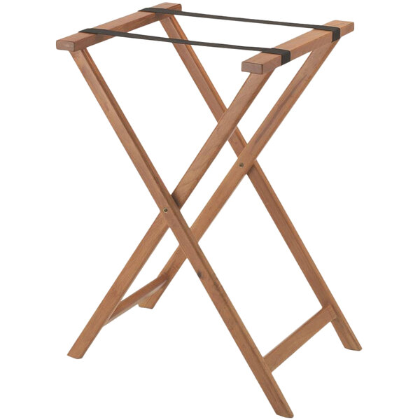 A wooden Aarco folding tray stand with a black strap.