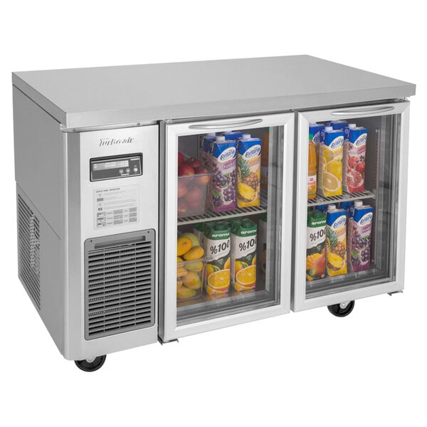 A Turbo Air undercounter refrigerator with two glass doors filled with drinks.