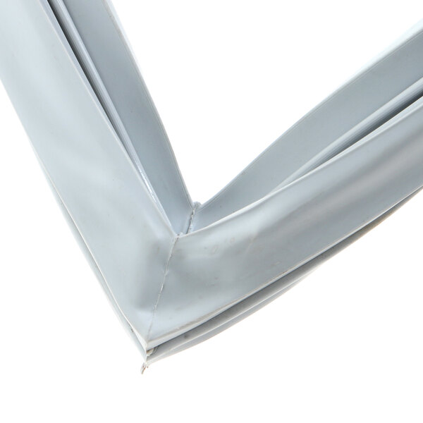 A close-up of a white plastic gasket corner for a Kolpak walk-in refrigerator.