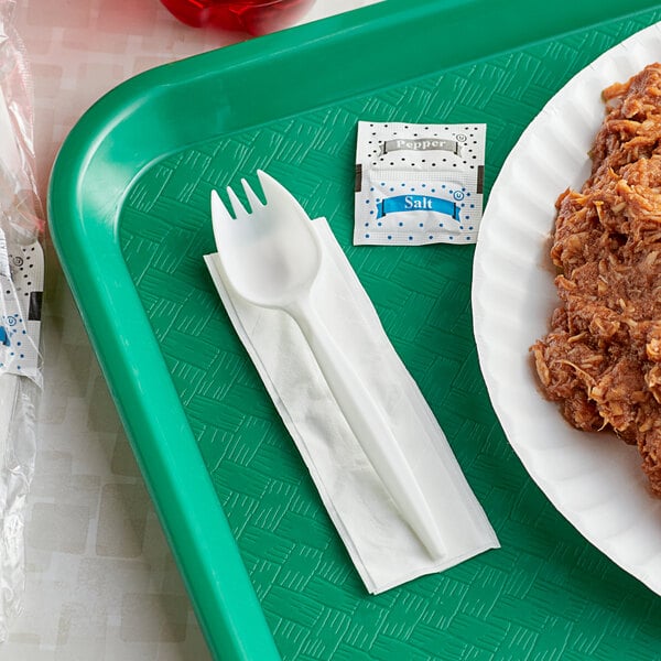 A tray of food with a spork and a napkin on it.
