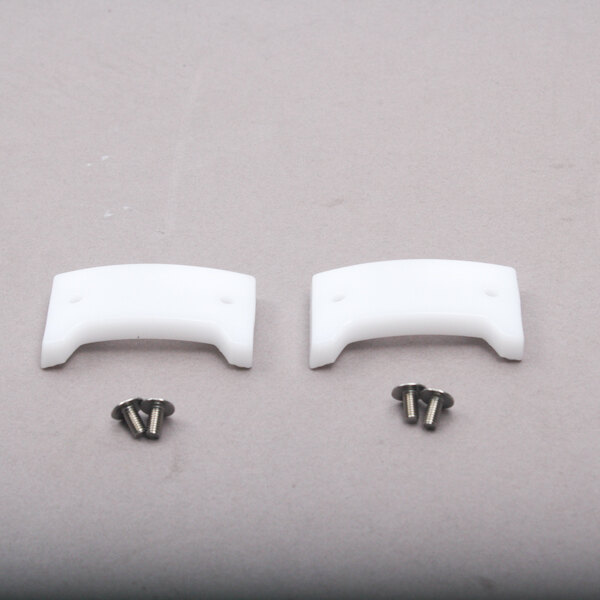 A pair of white plastic Robot Coupe lock bushings.