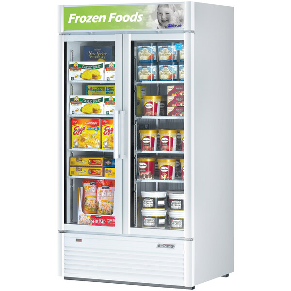 A Turbo Air white glass door freezer filled with a variety of products.