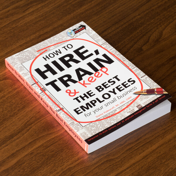 A book titled "How to Hire, Train & Keep the Best Employees" on a table.