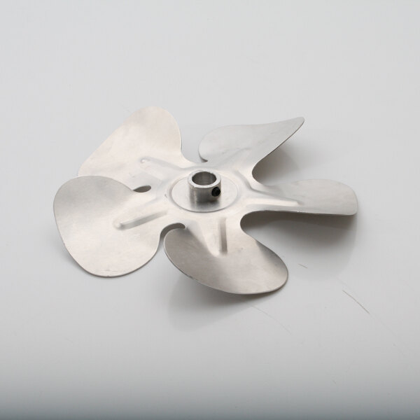 A Middleby Marshall metal fan blade on a white surface.