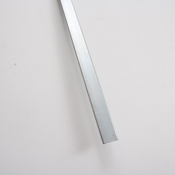 A long rectangular galvanized metal bar on a white surface.