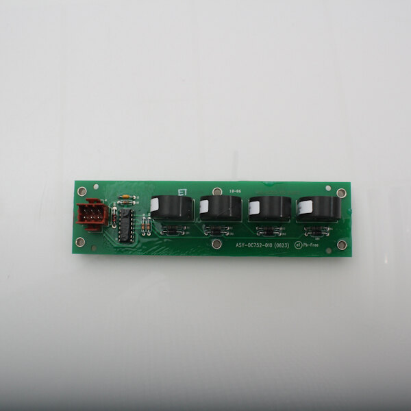 A close up of a green Wells convection oven current detection assembly circuit board with black buttons.