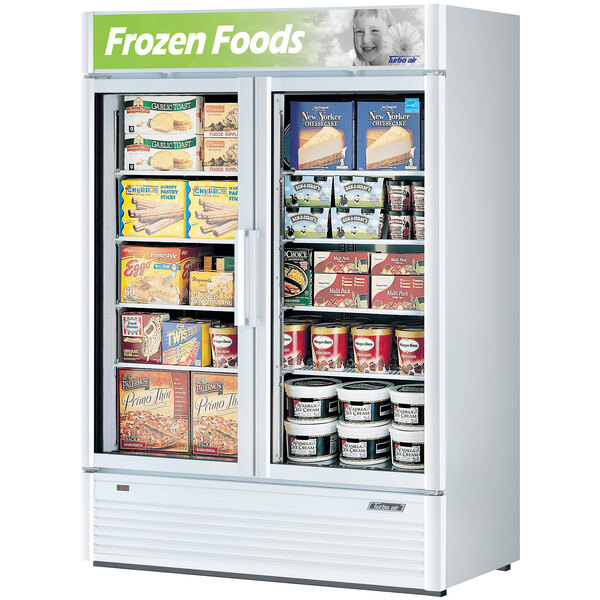 A Turbo Air white glass door freezer filled with a variety of food and drinks.