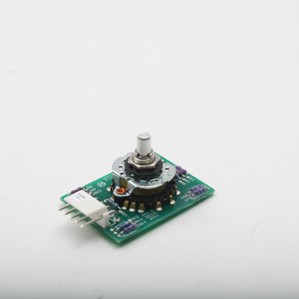 A close-up of a small green circuit board with a metal knob.
