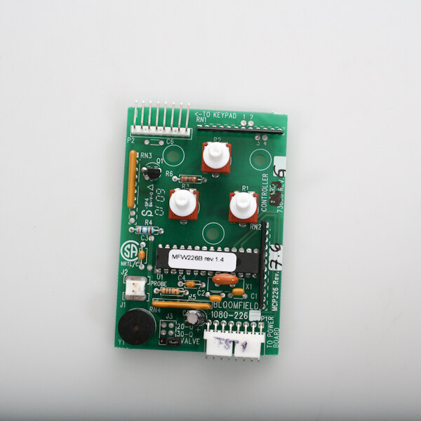 A green circuit board with white knobs and buttons.