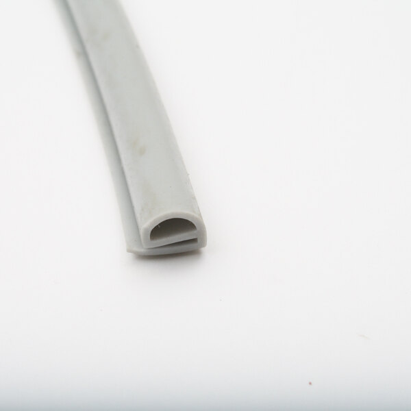 A close-up of a white rubber gasket with a small end.