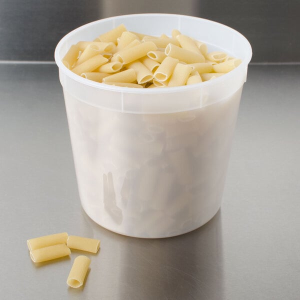 A 2.7 quart translucent deli container filled with pasta on a table.