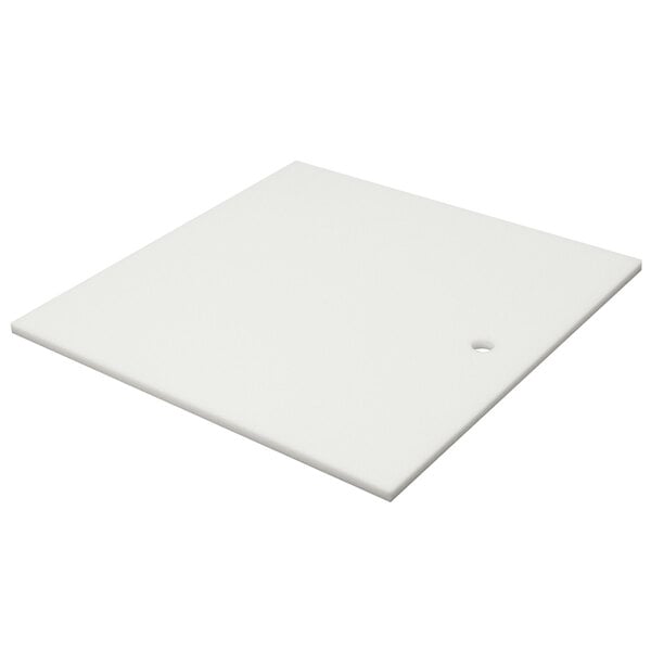 A white square cutting board with a hole.