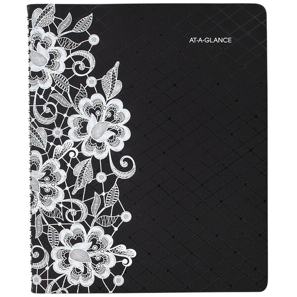A black and white At-A-Glance appointment book with white lace on it.