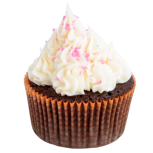 An Ateco orange striped baking cup with a cupcake, white frosting, and pink sprinkles.