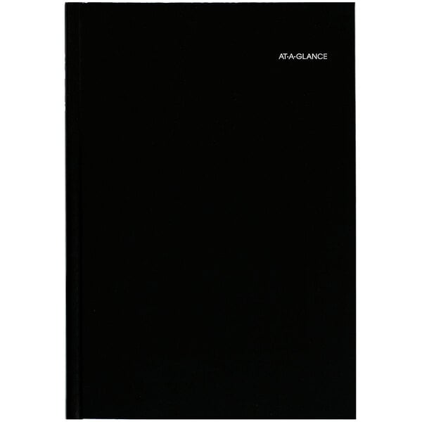 A black rectangular DayMinder hardcover planner with white text.