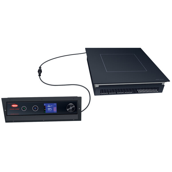 A black Hatco Rapide Cuisine countertop induction range with a wire.