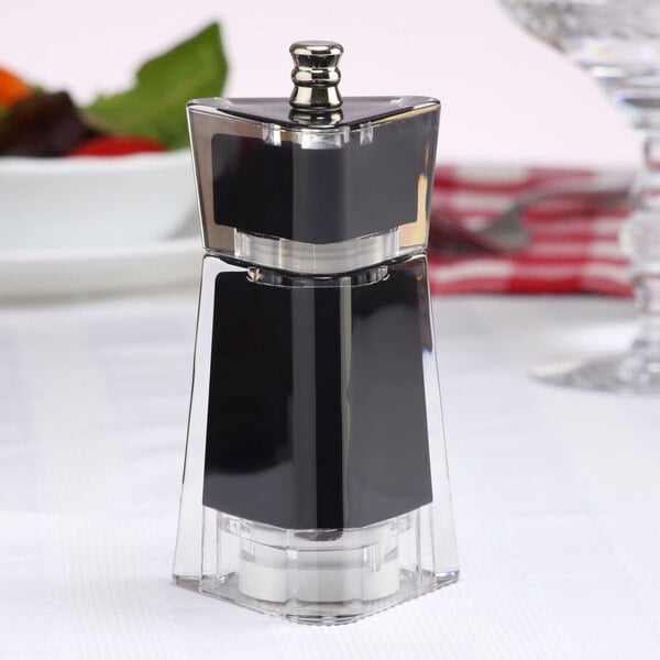 A black and silver Chef Specialties Kate salt or pepper mill on a table.