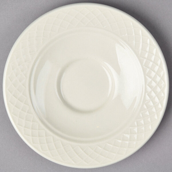A close-up of a white Homer Laughlin saucer with a pattern on it.