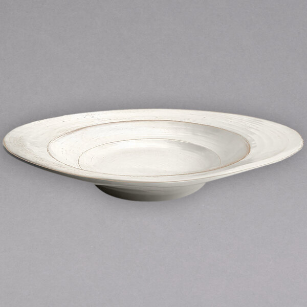 An off white melamine bowl with an irregular rim.
