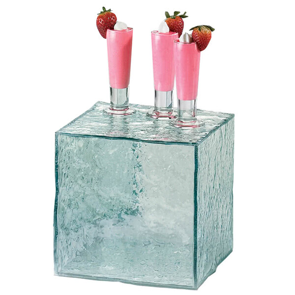 A Cal-Mil glass cube riser with pink drinks inside.