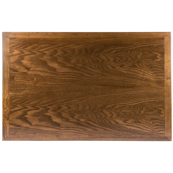 A BFM Seating Autumn Ash veneer wood table top with a wood surface.