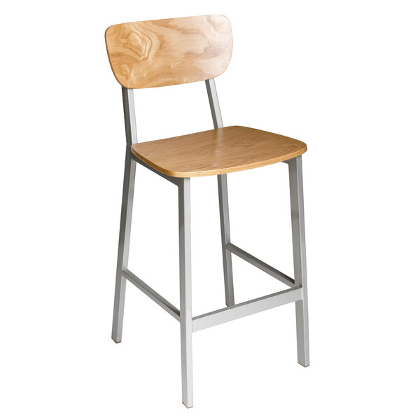 A BFM Seating Hamilton bar stool with a wooden seat and back and silver legs.