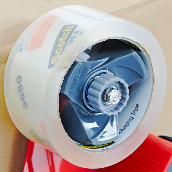 A roll of 3M Scotch clear packaging tape with a red screw on the side.