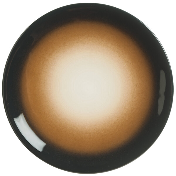 A brown and black porcelain plate with a circular design.