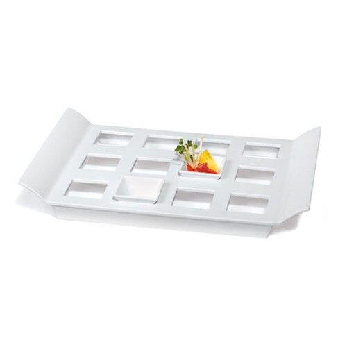 A white rectangular melamine tray with square slots holding small square dishes.